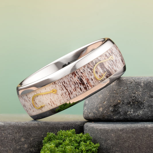 Fishing hook ring on a rock, the ring is inlayed with antler and fishing hooks.