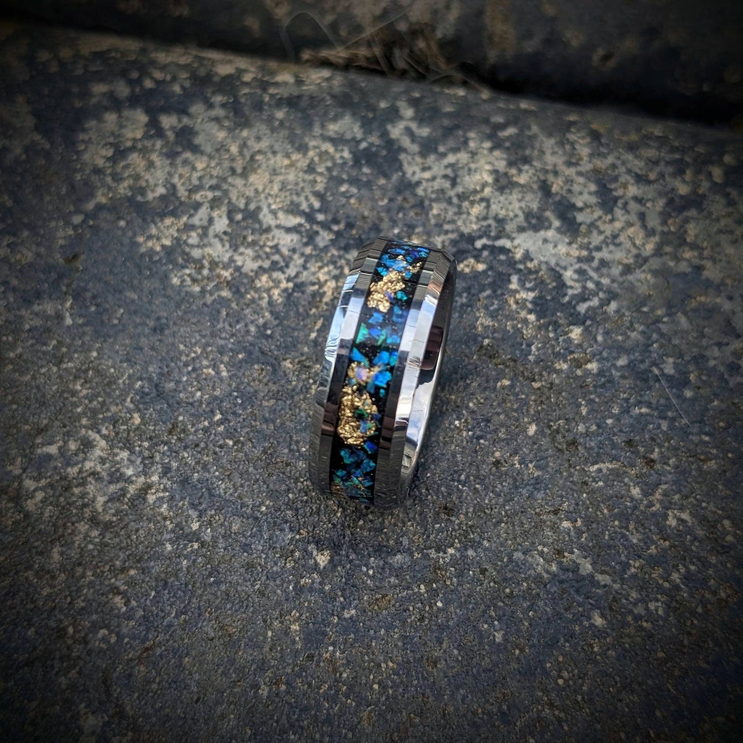 This stunning galaxy ring combines the strength of polished tungsten with the celestial allure of blue opals and elegant gold leaf. The opal inlay reflects a galaxy of colors, creating a unique, ever-changing pattern. Comfortable and scratch-resistant, this ring is perfect for daily wear or special occasions. It’s an ideal choice for anyone who wants to celebrate their love for the stars and add a touch of cosmic wonder to their jewelry collection.