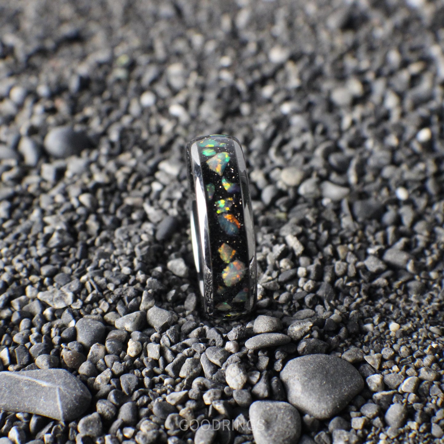 Modern silver ring with a 6mm width, highlighted by a black inlay and radiant white multicolor opals.