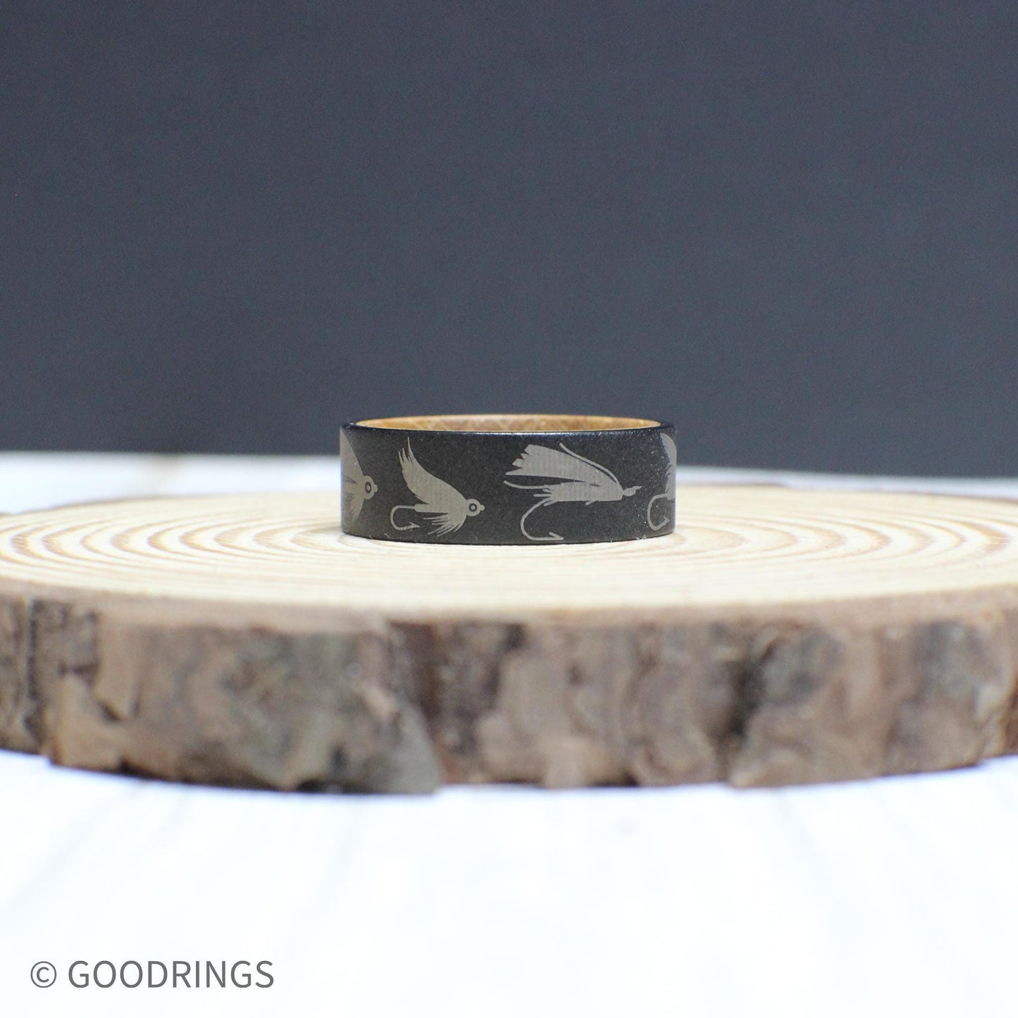 Engraved tungsten fly fishing ring with a whiskey barrel wood interior—durable, stylish, and perfect for anglers.