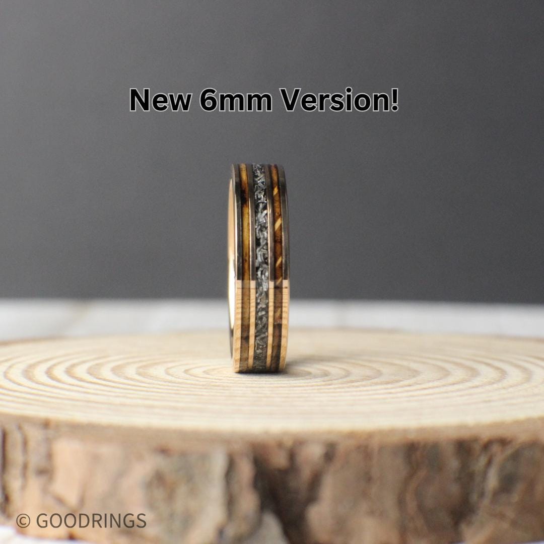 Meteorite wedding band with charred whiskey barrel and rose gold in a 6mm wide core.