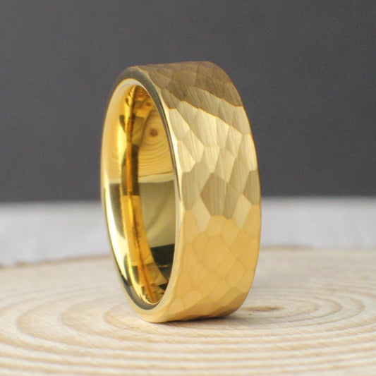 A sleek 8mm tungsten ring with a hammered texture and a brilliant 18K gold plated finish. The minimalist design makes it ideal for those who prefer simple yet bold jewelry. Comes with a ring box, black silicone backup band, and ring sizer. Backed by a lifetime warranty with free returns and exchanges, this ring is crafted for comfort, durability, and timeless everyday wear or as a wedding band.