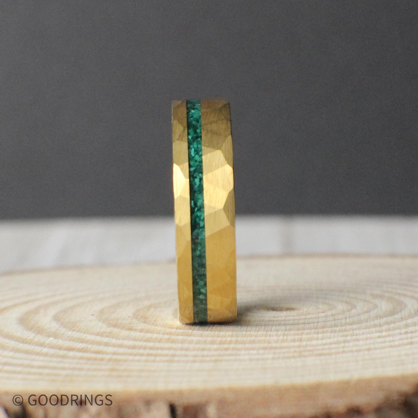 Close-up of the 6mm Verdant Edge ring, featuring a hammered gold exterior and an offset inlay of crushed malachite. The medium width balances comfort with presence, showcasing the earthy elegance of the green and gold contrast. Ideal for someone seeking a refined and nature-inspired design with a classic feel.