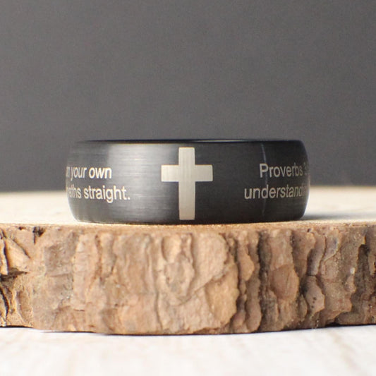 This 8mm brushed tungsten ring features a domed profile and an optional engraved cross, making it an ideal symbol of faith and commitment. Customizable with your choice of Bible verse or meaningful quote, this ring is perfect as a wedding band, promise ring, or spiritual gift. Its durable design and personalized message create a lasting keepsake for special moments and everyday inspiration.