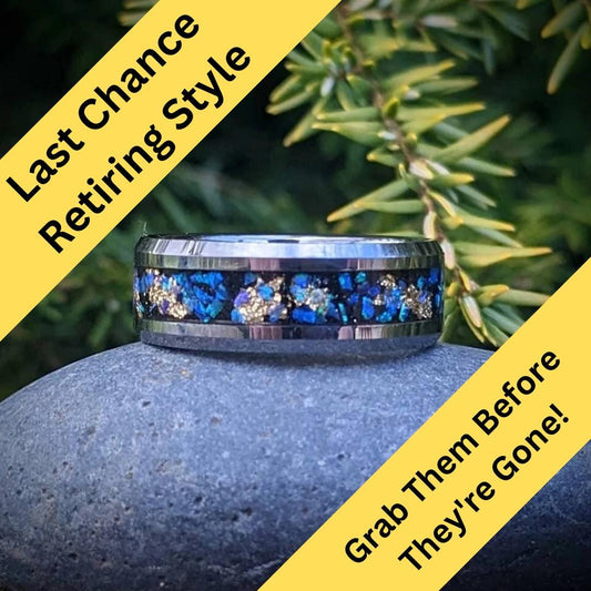 This galaxy-inspired ring features a polished tungsten band inlaid with shimmering blue opals and delicate gold leaf accents. The vibrant opals reflect light beautifully, creating a mesmerizing galaxy effect. Designed for comfort and durability, this ring is scratch-resistant and perfect for everyday wear. A stunning statement piece that combines timeless elegance with celestial wonder, ideal for expressing your unique style and love for the stars.