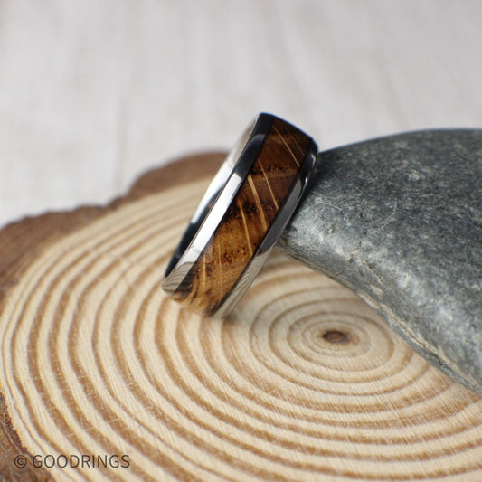 A men’s tungsten wedding ring featuring real whiskey barrel wood inlay and a domed profile. The polished edges and smooth curvature give the band a timeless shape, while the rustic wood adds warmth and heritage. Designed for comfort, strength, and everyday wear.