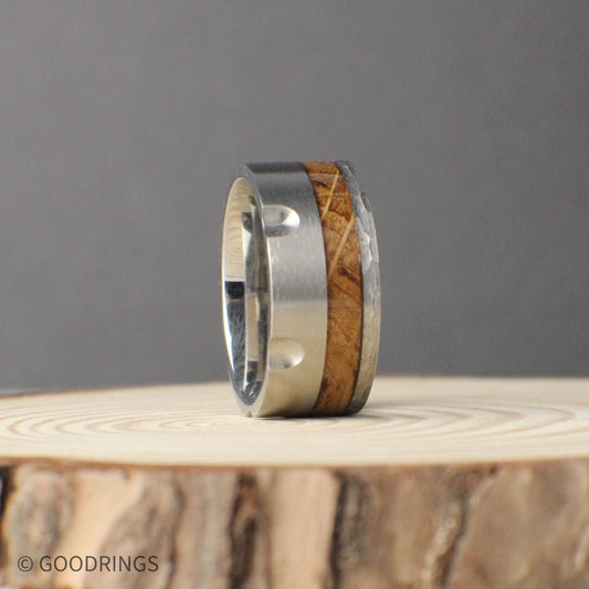 A powerful 10mm tungsten ring designed to resemble the chamber of a revolver, complete with recessed grooves for a bold, industrial look. The inlay of charred whiskey barrel wood adds a rustic and meaningful contrast, bringing history and warmth to the durable tungsten band. Built with a comfort fit, this unique design is perfect as a men’s wedding band or statement piece for anyone who values strength and originality.