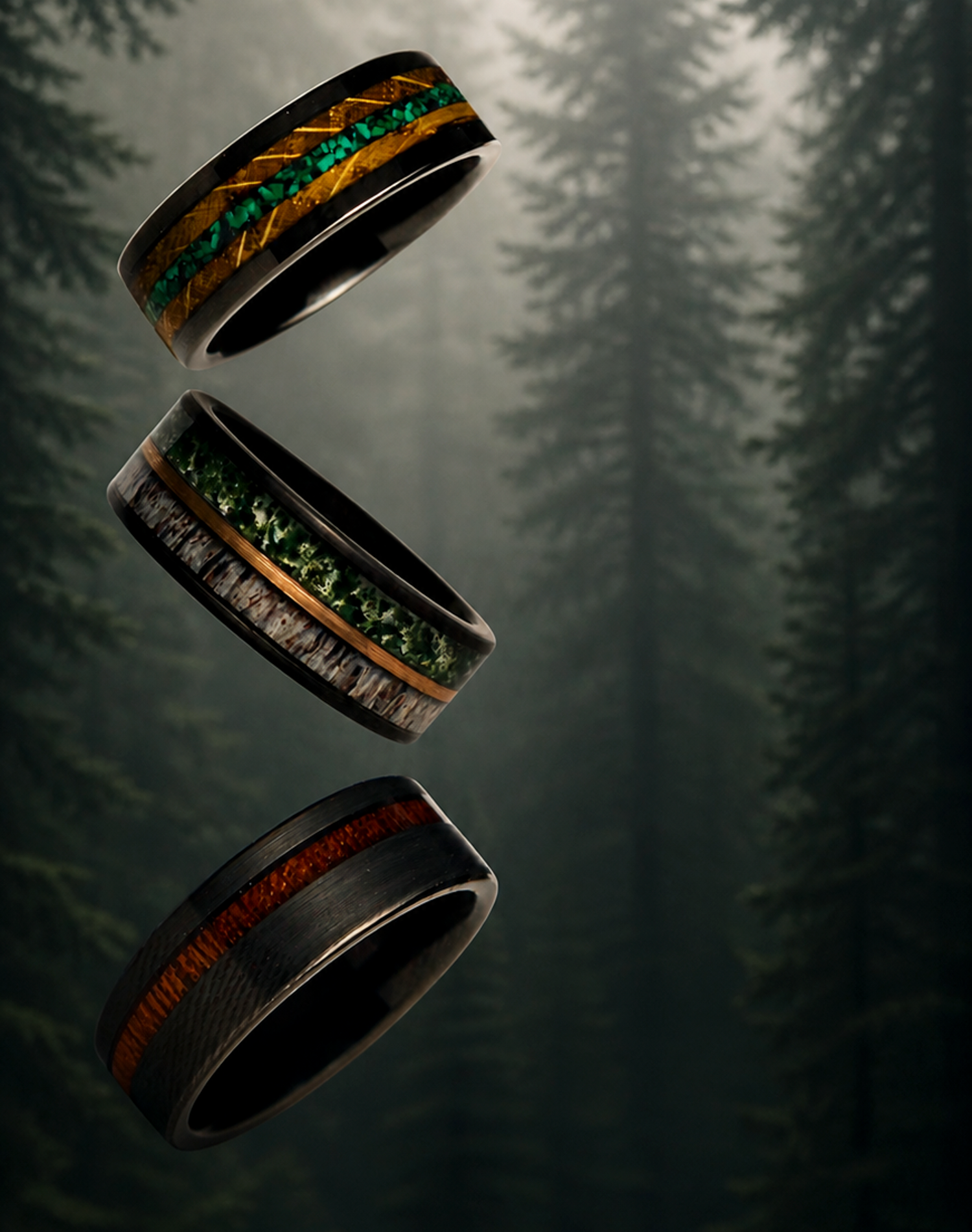 Three black rings with green and brown inlays on a dark background