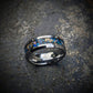 Our galaxy-inspired tungsten ring is crafted with dazzling blue opals and intricate gold leaf inlays that evoke the breathtaking beauty of the night sky. The polished tungsten band offers superior durability and a smooth, comfortable fit. This ring is perfect as a statement accessory or a meaningful gift, combining luxury with celestial charm. It’s designed to inspire awe and remind you of the infinite possibilities that the universe holds each time you wear it.