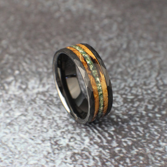 Black ceramic ring inlayed with bunt whiskey barrel and crushed moss agate