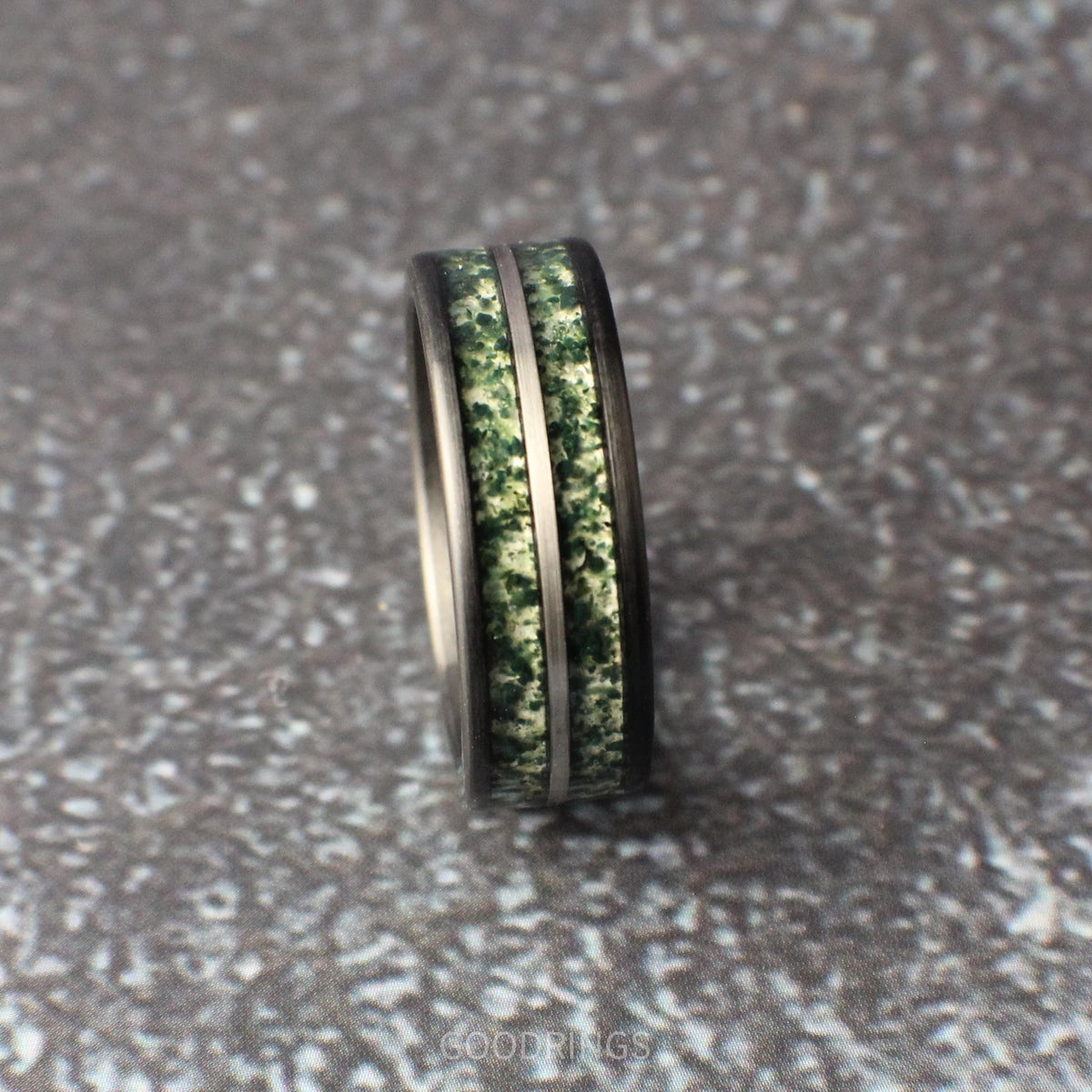 Men’s 8mm brushed black tungsten band, inlaid with moss agate and silver line, unique nature-inspired ring design for wedding or anniversary.