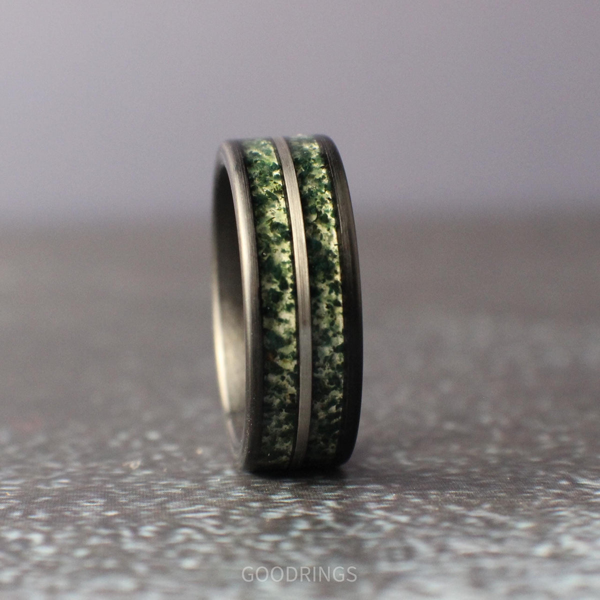 8mm brushed black tungsten men's ring with two channels of moss agate inlay separated by a silver line, durable and stylish wedding or gift ring.