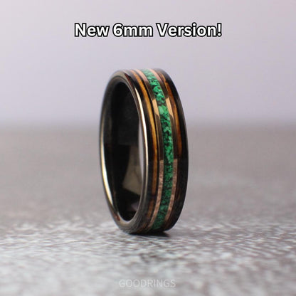 A 6mm tungsten ring with a malachite center inlay, flanked by whiskey wood on both sides, separated by rose gold lines. Sleek and stylish with a modern, natural appeal.