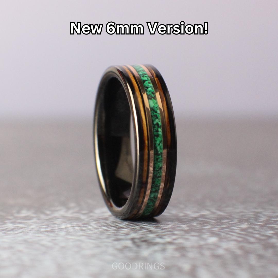 A 6mm tungsten ring with a malachite center inlay, flanked by whiskey wood on both sides, separated by rose gold lines. Sleek and stylish with a modern, natural appeal.