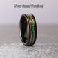 A 6mm tungsten ring with a malachite center inlay, flanked by whiskey wood on both sides, separated by rose gold lines. Sleek and stylish with a modern, natural appeal.