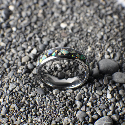 A polished silver ring, 6mm wide, featuring a black inlay layered with shimmering white opals.