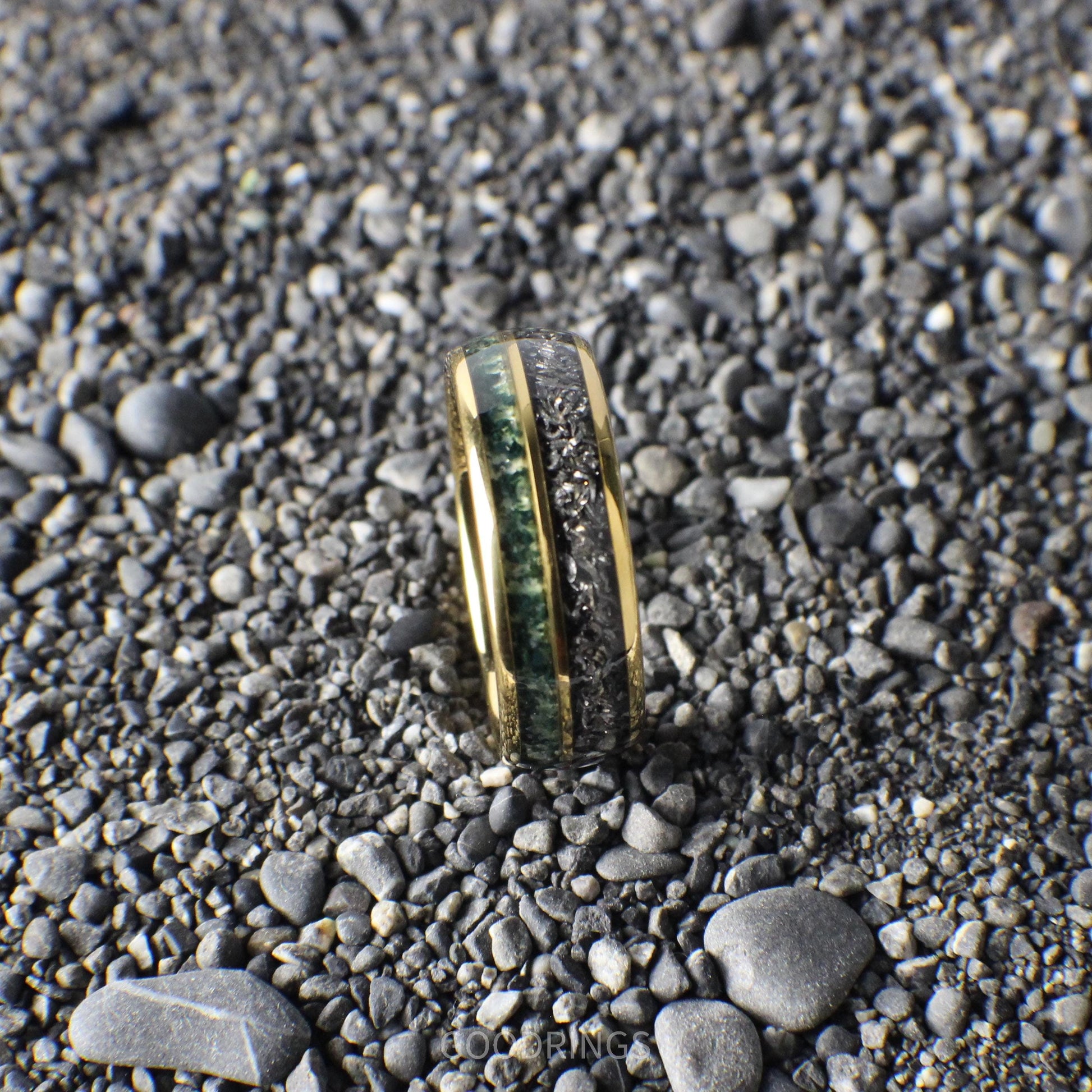A domed yellow gold ring with an 8mm width, featuring a striking inlay of shimmering meteorite and vibrant green moss agate.