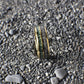 A domed yellow gold ring with an 8mm width, featuring a striking inlay of shimmering meteorite and vibrant green moss agate.