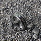 Silver-core ring with a bold black base, topped with vibrant white opals for a dazzling, contemporary look.