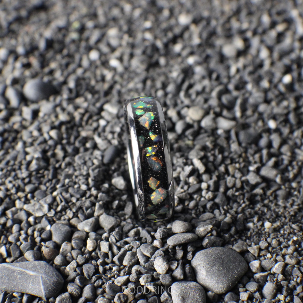 Stunning silver wedding band with a black inlay and luminous white opals, perfect for a meaningful gift.