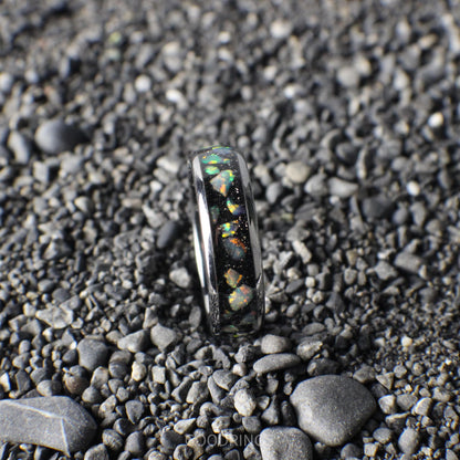 Stunning silver wedding band with a black inlay and luminous white opals, perfect for a meaningful gift.