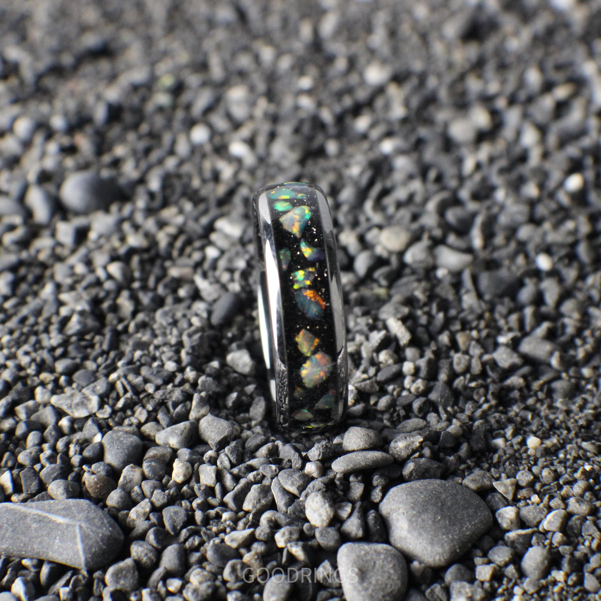 Modern silver ring with a 6mm width, highlighted by a black inlay and radiant white multicolor opals.