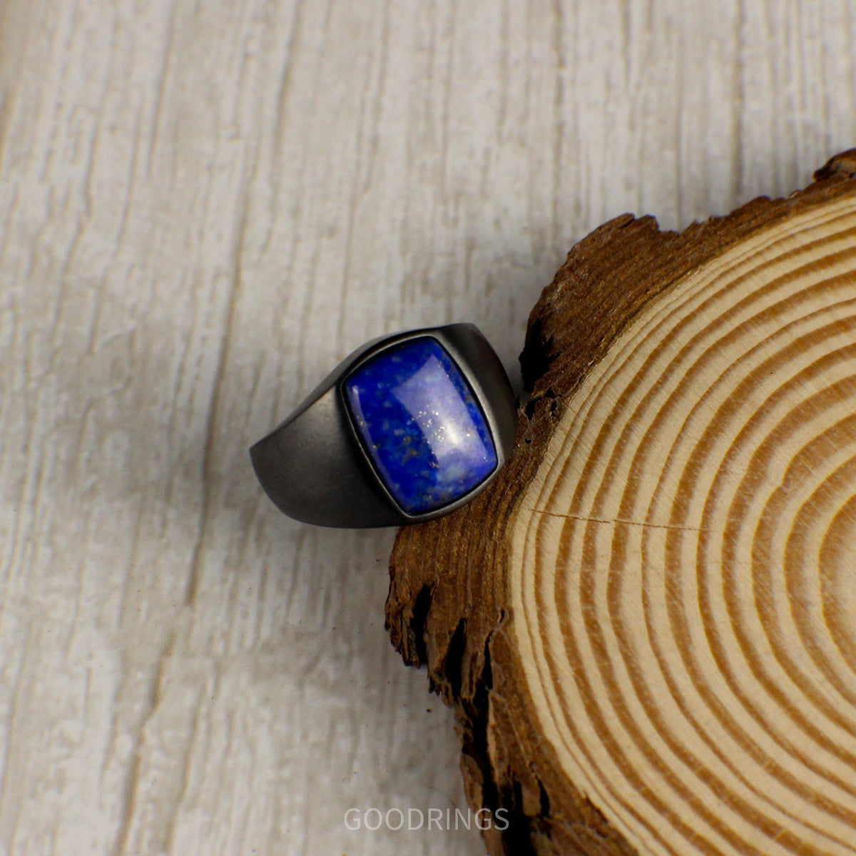 Men's black tungsten ring featuring a rich blue lapis lazuli centerpiece, perfect for making a statement with elegance.