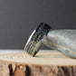 Modern tungsten wedding ring with celestial meteorite and earthy moss agate inlays.