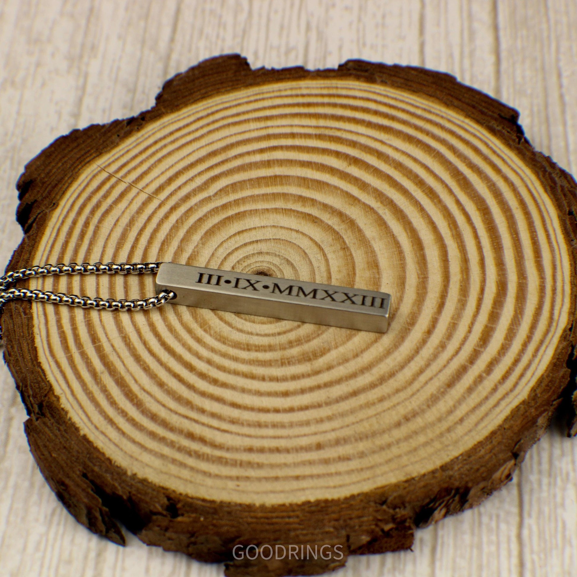 A brushed stainless steel bar necklace with a 22-inch durable box chain, offering engraving on the front, back, and both sides for a personalized touch.