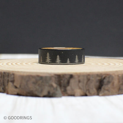 Tungsten and whiskey barrel wood ring showcasing its engraved forest design and warm wooden interior.