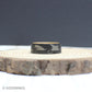 Fly fishing-themed tungsten ring with a sandblasted texture, engraved lure designs, and a whiskey barrel wood inlay.