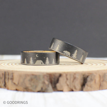 Stylish and rugged men’s wedding band with a detailed outdoor engraving on tungsten and a whiskey barrel wood interior, perfect for nature lovers.