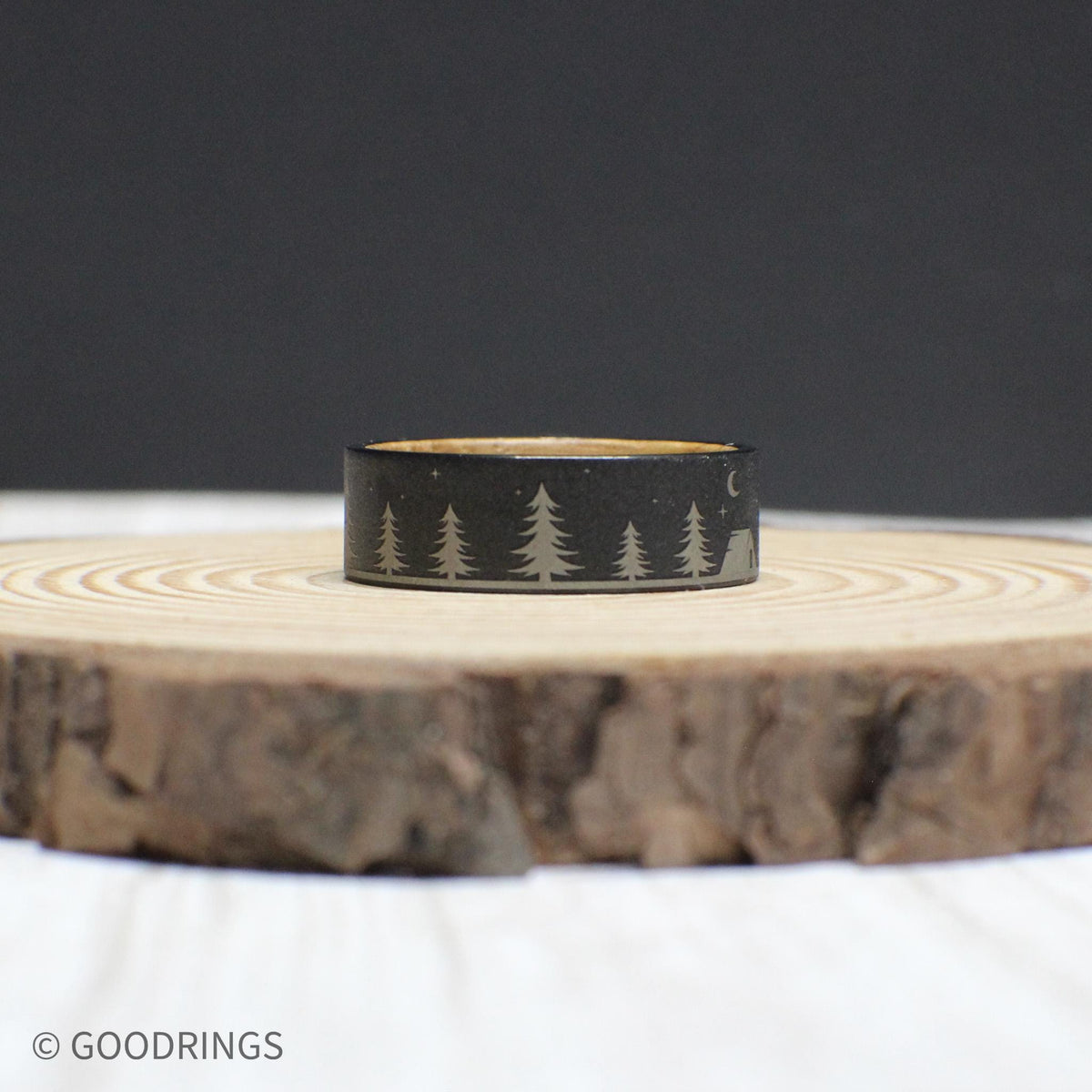 Rugged yet elegant wedding band with a camping-inspired engraving on the tungsten exterior and a whiskey barrel wood interior.