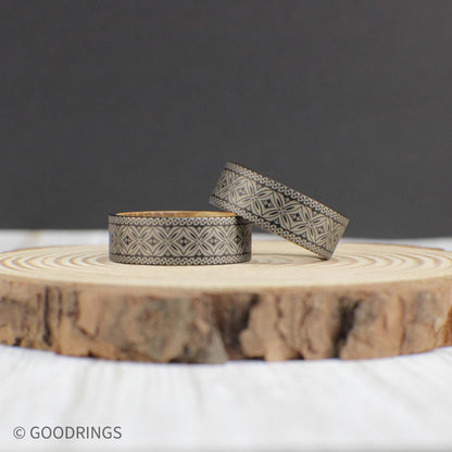 8mm tungsten wedding band showcasing a fully engraved Polynesian pattern with a smooth whiskey barrel wood lining inside.