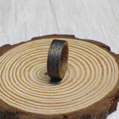 8mm tungsten wedding band featuring a fully engraved Polynesian design around the exterior with a whiskey barrel wood interior.