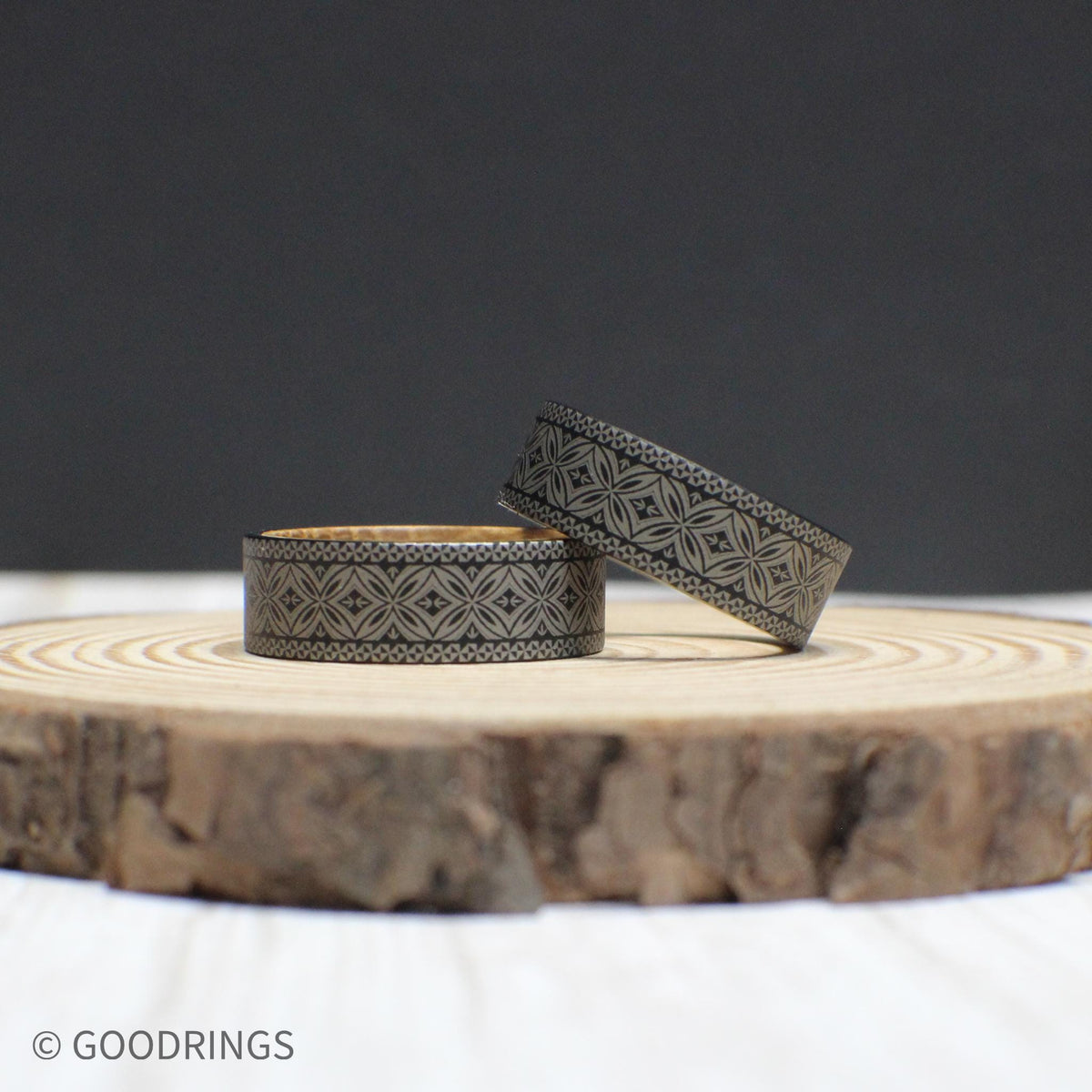 Durable tungsten ring with a Polynesian engraving symbolizing strength and tradition, complemented by a whiskey barrel wood core.
