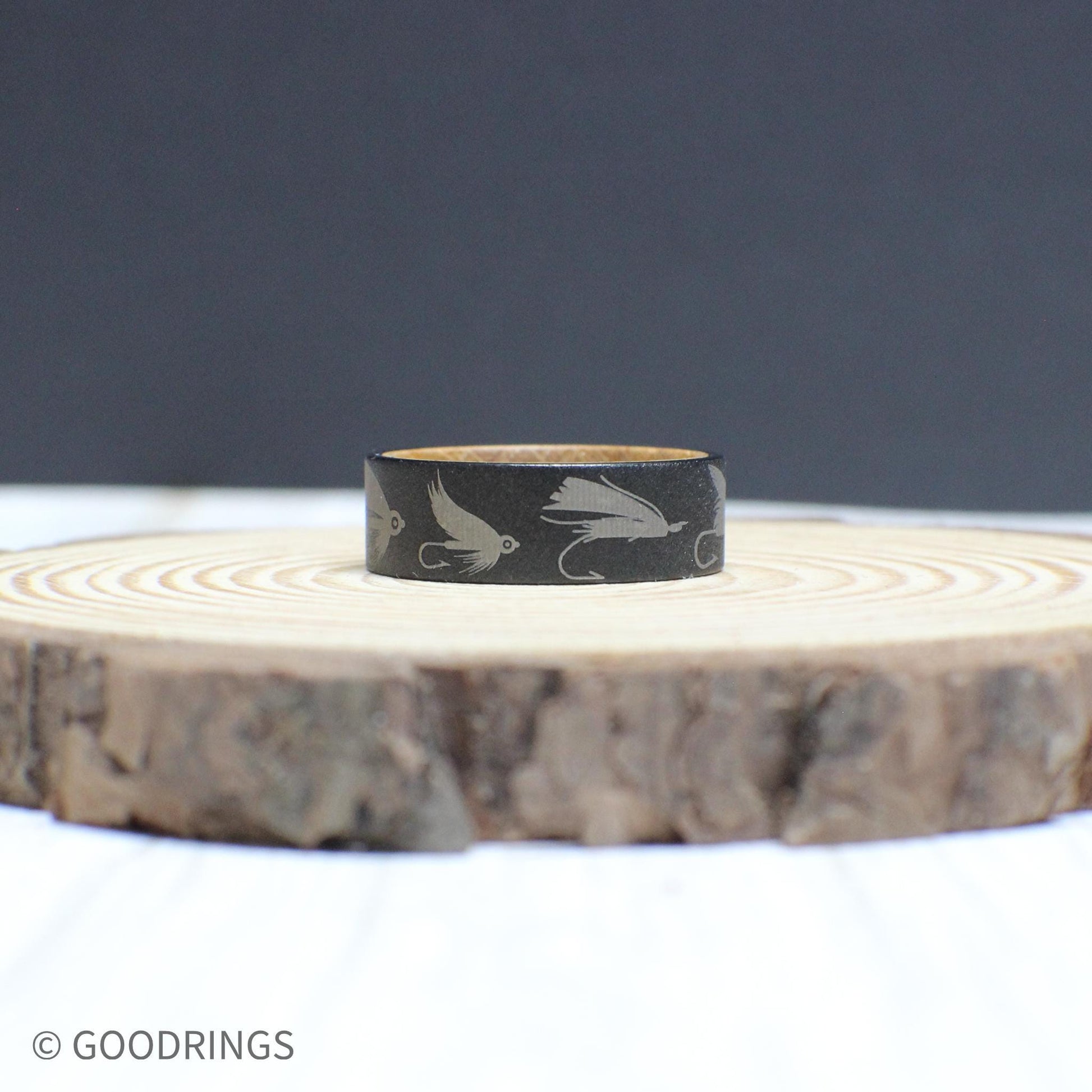 Engraved tungsten fly fishing ring with a whiskey barrel wood interior—durable, stylish, and perfect for anglers.
