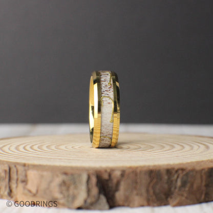 An 8mm gold tungsten wedding band with natural antler inlay and a bold fishing hook design, ideal for anglers and nature lovers.