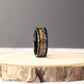 This bold tungsten ring features a hammered finish, half-burnt whiskey barrel wood, and genuine meteorite inlay, symbolizing strength and the universe’s mystery.