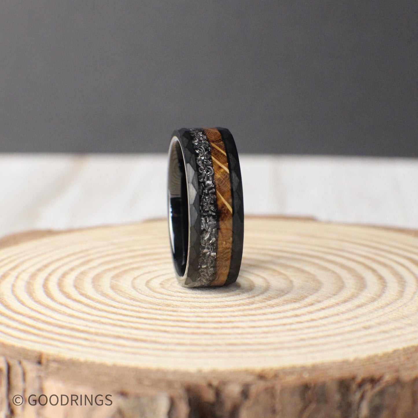 A striking 8mm tungsten band showcasing a unique mix of whiskey barrel wood and meteorite, with a rugged hammered texture for a timeless, durable look.