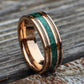 Rose gold tungsten ring with charred whiskey barrel and crushed malachite inlay. The warm tones of wood contrast beautifully with vivid green malachite, symbolizing transformation and strength. Perfect for weddings or special occasions.