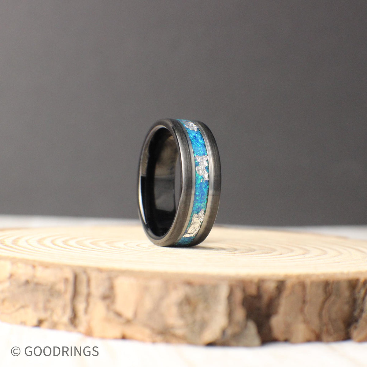 Elegant tungsten ring with vivid aquamarine opal and intricate silver leaf inlay. Polished silver lines provide contrast, making it a striking wedding or statement piece.
