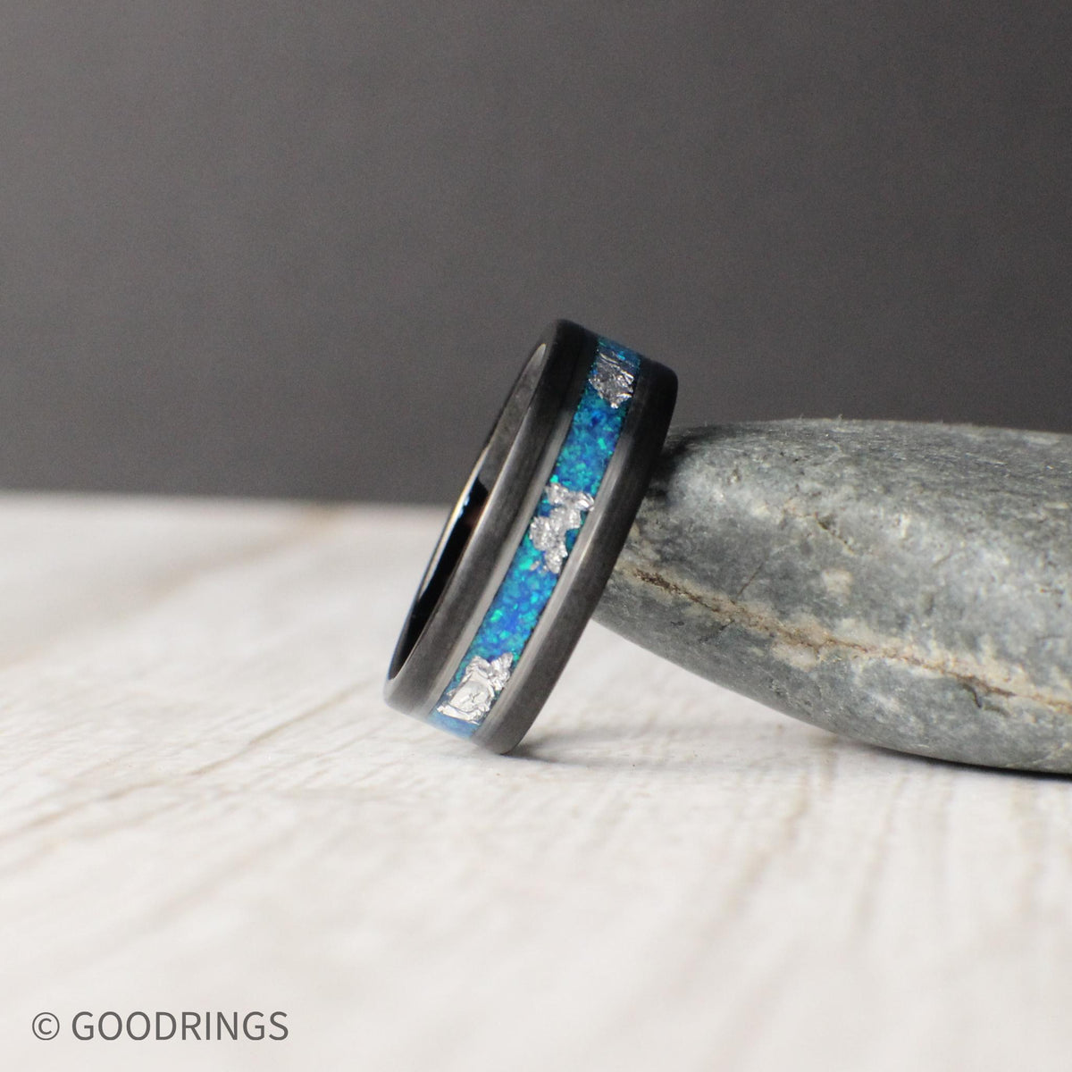 Ocean-inspired tungsten ring featuring aquamarine opal and silver leaf inlays. Polished silver accents enhance the vibrant hues, blending strength and elegance.