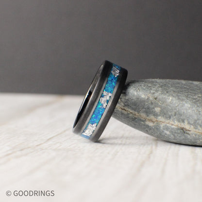 Ocean-inspired tungsten ring featuring aquamarine opal and silver leaf inlays. Polished silver accents enhance the vibrant hues, blending strength and elegance.