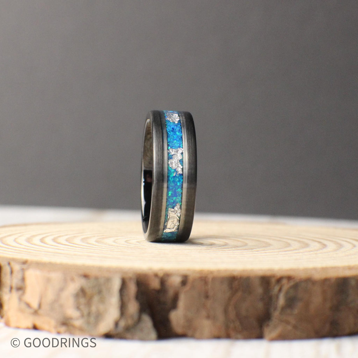 Aquamarine opal tungsten band with silver leaf inlay and polished silver accents. A perfect balance of modern durability and timeless beauty, ideal for special occasions.