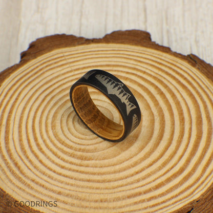 Tungsten ring with rustic whiskey wood lining, engraved with a salmon and tree line design, available with single or multiple fish options.