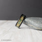 Black tungsten ring featuring a moss agate inlay with unique patterns and delicate gold leaf accents, bordered by gold lines for a refined finish. Includes a gift box, ring sizer, and silicone ring, with lifetime warranty and free exchanges.