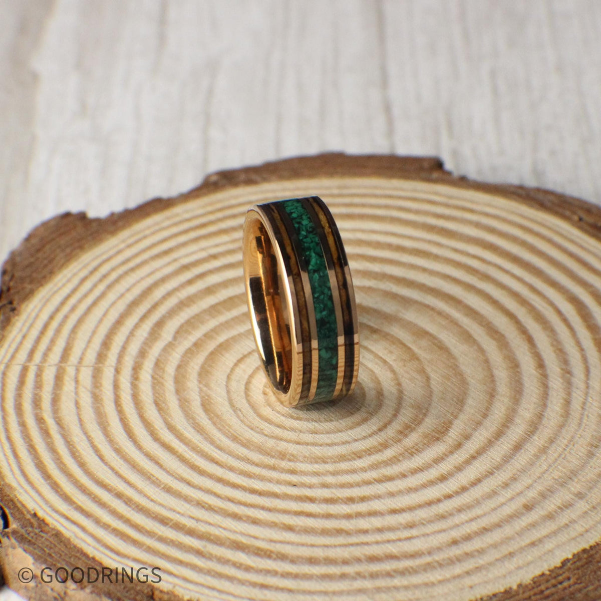 Durable rose gold tungsten ring with charred whiskey barrel wood and a center line of crushed malachite. A perfect blend of elegance and natural charm, ideal for weddings or gifts.