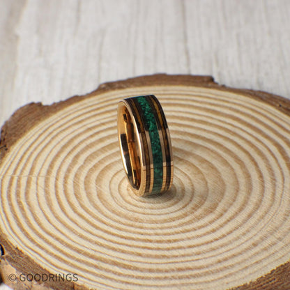 Durable rose gold tungsten ring with charred whiskey barrel wood and a center line of crushed malachite. A perfect blend of elegance and natural charm, ideal for weddings or gifts.