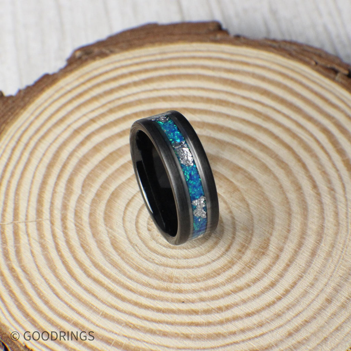 Tungsten ring with shimmering aquamarine opal and delicate silver leaf inlay. Polished silver lines add contrast, making this piece ideal for weddings or meaningful occasions.